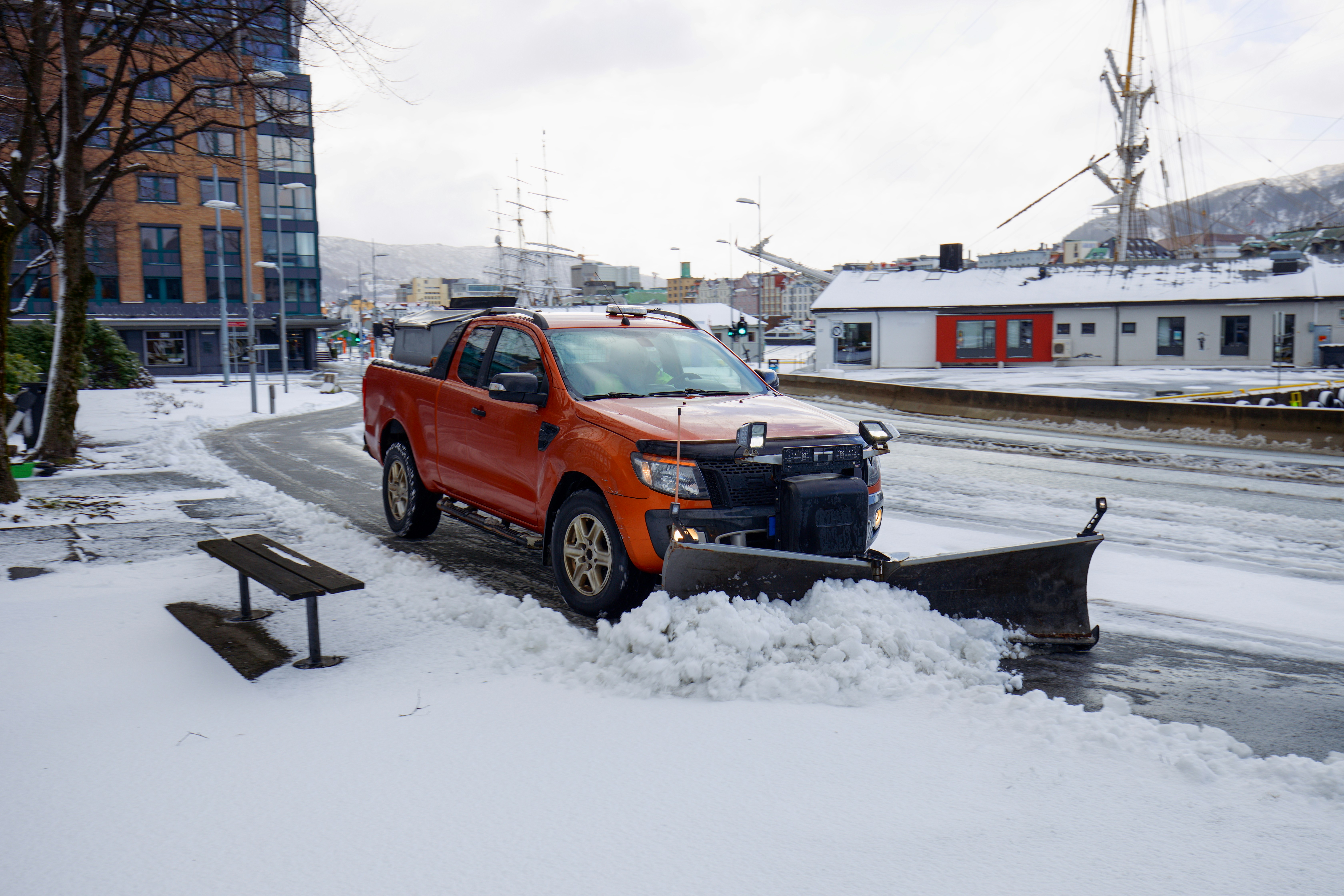 Snow plow clearing a commercial parking lot