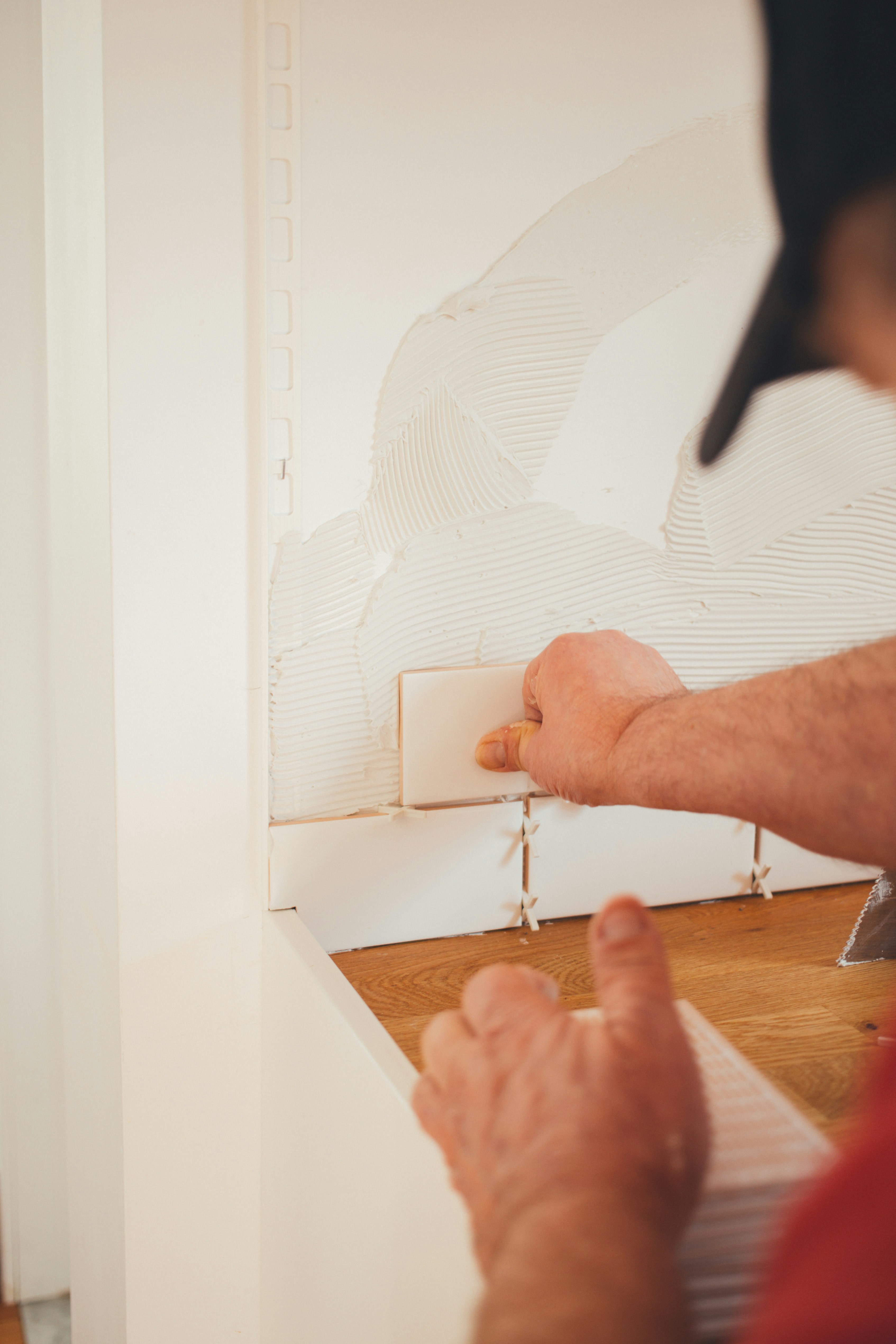 Tile setter working on a bathroom